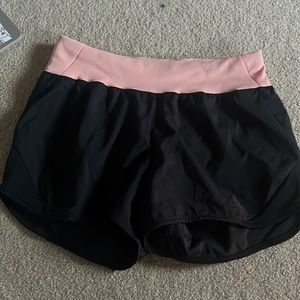 pink and black athletic shorts from Adidas